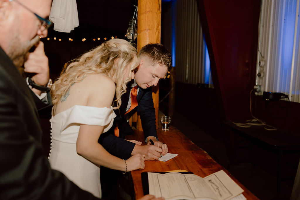 Bride and groom signing marriage license  