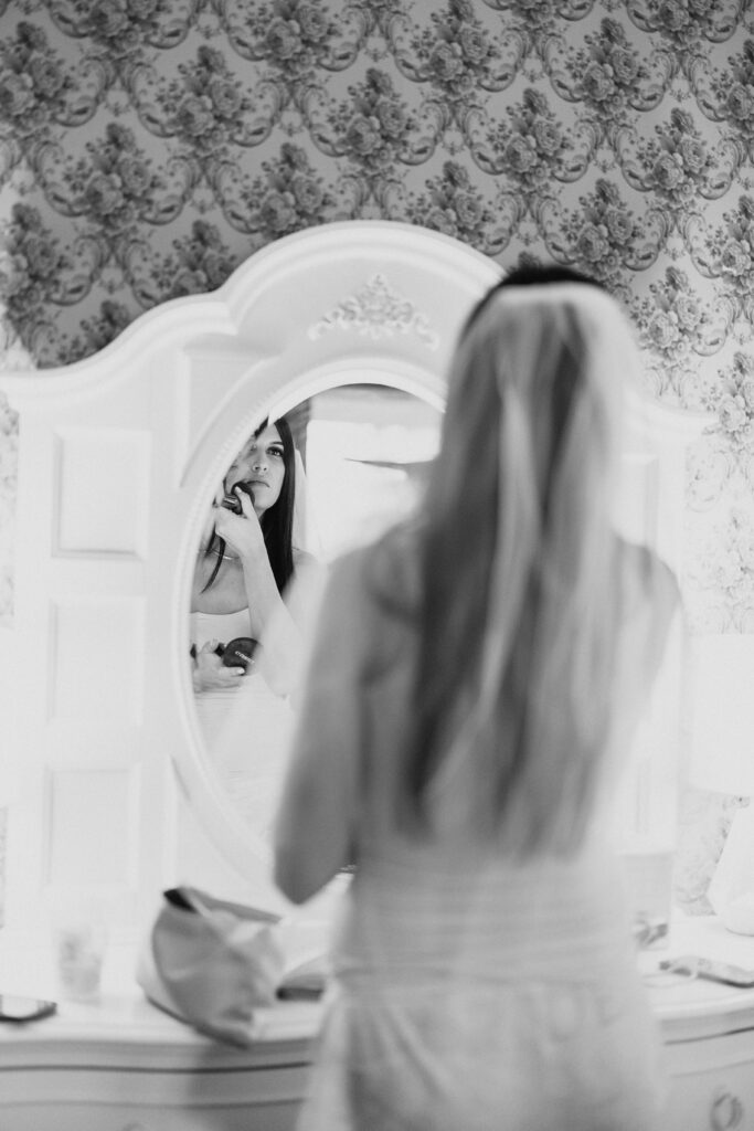 bride putting on makeup before wedding ceremony