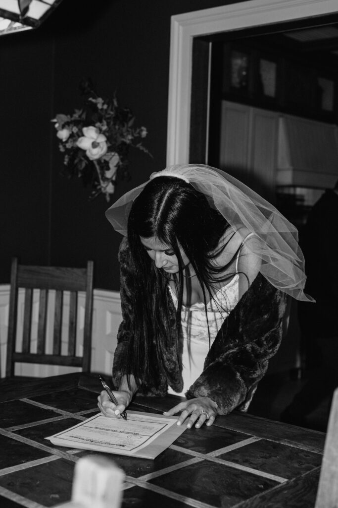 bride signing marriage certificate